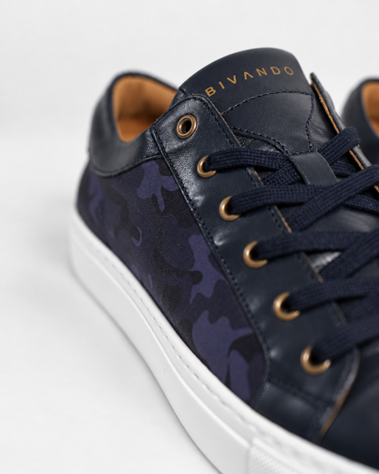Close-up of the Bivando Midnight Camo Sneaker: blue camo nylon, navy leather, gold eyelets and embossed Bivando logo